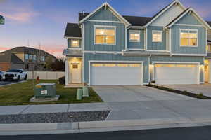 Craftsman house with board and batten siding, concrete driveway, and an attached garage