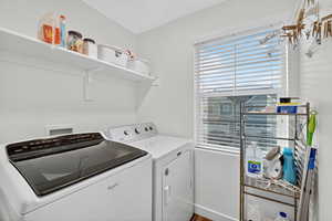 Laundry room featuring independent washer and dryer and baseboards