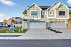Craftsman-style home with board and batten siding, concrete driveway, a garage, and a shingled roof