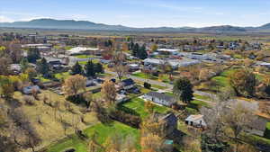 Aerial overview of property's location with nearby suburban area and mountains