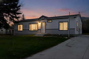 View of front of house with crawl space and a front yard