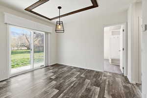 Unfurnished dining area featuring dark wood-style flooring