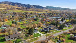 Aerial overview of property's location featuring mountains and nearby suburban area