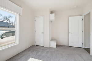 Unfurnished bedroom with light colored carpet