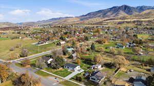 Aerial overview of property's location featuring mountains, nearby suburban area, and rural landscape