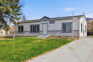 View of front facade featuring roof with shingles and crawl space