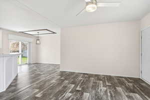 Empty room featuring dark wood finished floors and ceiling fan