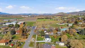 Aerial view of property and surrounding area with mountains and rural landscape