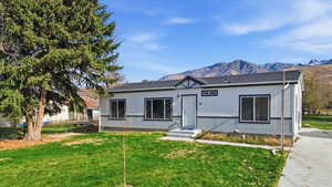 View of front of house with a mountain view and a shingled roof