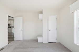 Unfurnished bedroom featuring light colored carpet