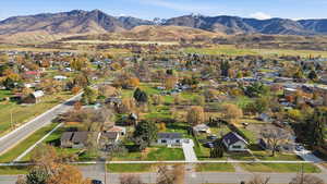 View of property location featuring mountains and nearby suburban area