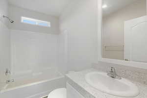 Bathroom with vanity and  shower combination