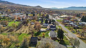 Aerial view of property's location featuring nearby suburban area and mountains