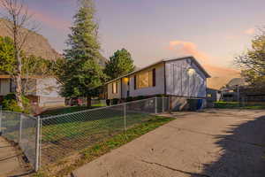 View of front facade with a fenced front yard, a gate, and concrete driveway