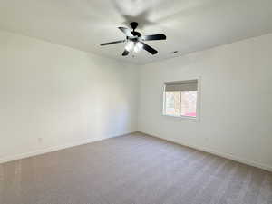 Spare room with a textured ceiling and light colored carpet