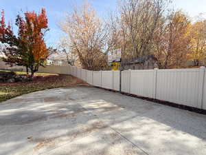 Fenced backyard with basketball hoop