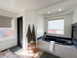 Bathroom featuring a bath, light tile patterned floors, a shower stall, and recessed lighting