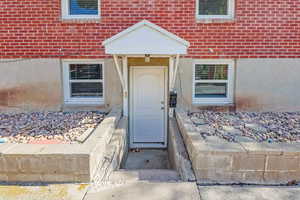 Property entrance featuring brick siding