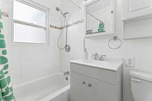 Bathroom featuring shower / bath combo and vanity