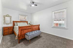 Carpeted bedroom with baseboards and ceiling fan
