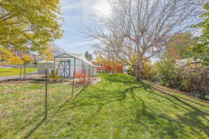 View of yard with an outbuilding