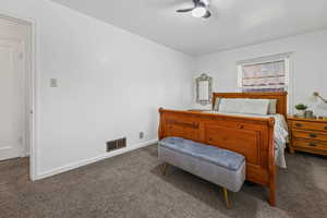 Carpeted bedroom with baseboards and a ceiling fan
