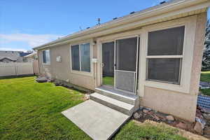 Back of property featuring stucco siding and entry steps