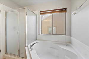 Bathroom featuring a shower stall and a garden tub