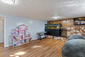 Family Room with laminate floors, a textured ceiling, and fireplace