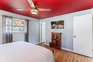 Bedroom featuring laminate floors and ceiling fan