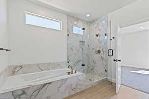Bathroom with a garden tub, a marble finish shower, and carpet floors