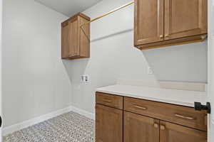 Laundry area featuring hookup for a washing machine and cabinet space