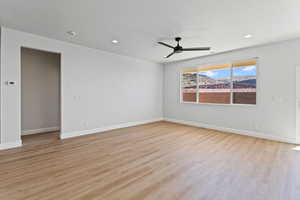 Empty room with light wood-style flooring, a ceiling fan, and recessed lighting