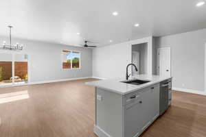 Kitchen with light wood finished floors, gray cabinets, recessed lighting, a kitchen island with sink, and ceiling fan