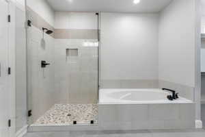 Bathroom with a stall shower, a bath, recessed lighting, and tile patterned flooring
