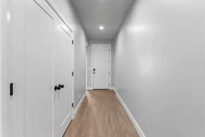 Corridor with recessed lighting and light wood-style flooring