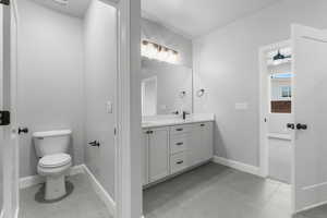 Bathroom featuring double vanity and light tile patterned flooring