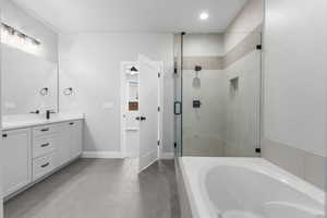 Full bath with a garden tub, vanity, a stall shower, light tile patterned floors, and recessed lighting