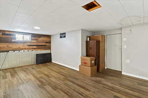 Below grade area featuring wooden walls and hardwood / wood-style floors