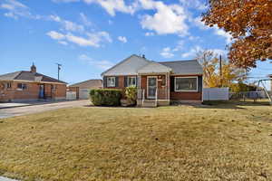 View of front of house featuring brick siding and a garage