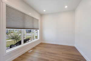 Front visiting room, featuring light wood-style floors and recessed lighting