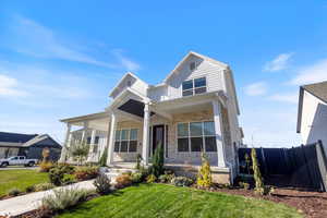 View of front facade featuring stone siding and covered porch