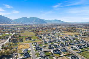 Aerial view of property's location featuring nearby suburban area and a mountain backdrop