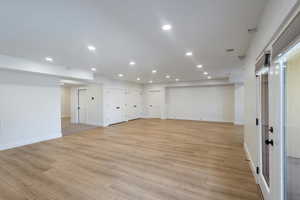 Large family room featuring recessed lighting and light wood-style floors