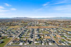 Aerial overview of property's location with nearby suburban area and a mountainous background