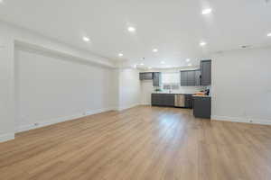 Living room with recessed lighting and light wood-type flooring
