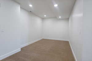 Den with carpet floors and recessed lighting