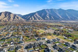 Aerial overview of property's location with nearby suburban area and a mountainous background
