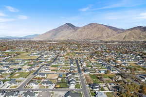 Aerial view of property's location with nearby suburban area and a mountain backdrop