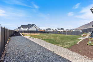 View of fenced backyard with space for an RV
